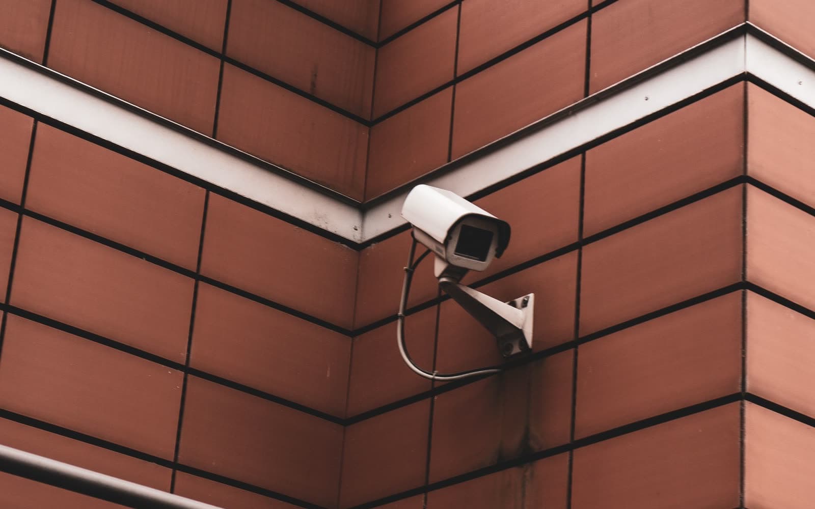 Security camera mounted on the corner of a brick building